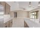 Bright living room with tile floors, modern ceiling fan, and access to patio at 20310 W Hubbard Rd, Buckeye, AZ 85326