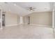 Open living area with tile flooring, ceiling fan, and multiple entryways at 20310 W Hubbard Rd, Buckeye, AZ 85326