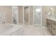 Elegant main bathroom with a soaking tub, tile accents, and walk in shower at 20310 W Hubbard Rd, Buckeye, AZ 85326