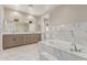 Spacious bathroom with marble tiling, a soaking tub, and double sink vanity at 20310 W Hubbard Rd, Buckeye, AZ 85326