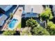 Aerial view featuring a private backyard with a kidney-shaped pool, green grass, mature trees and a covered patio at 25015 N 50Th Ave, Phoenix, AZ 85083