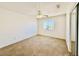 Cozy bedroom with carpet flooring, a ceiling fan, and a window for natural light at 25015 N 50Th Ave, Phoenix, AZ 85083
