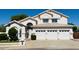 Attractive two-story home featuring a three-car garage and a neatly maintained front yard at 25015 N 50Th Ave, Phoenix, AZ 85083