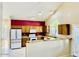 Bright kitchen featuring stainless steel refrigerator, granite counters, and ample cabinet space at 25015 N 50Th Ave, Phoenix, AZ 85083