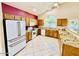 Bright kitchen featuring stainless steel refrigerator, granite counters, and ample cabinet space at 25015 N 50Th Ave, Phoenix, AZ 85083
