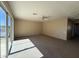Bright living room features carpet flooring, a ceiling fan, and sliding glass doors for indoor-outdoor flow at 25015 N 50Th Ave, Phoenix, AZ 85083