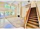 Staircase with railing leading to the open-concept living space with lots of natural light from large windows at 25015 N 50Th Ave, Phoenix, AZ 85083
