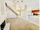 Spacious living room featuring a fireplace, carpet floors, and staircase, leading to additional living areas at 25015 N 50Th Ave, Phoenix, AZ 85083