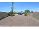 Backyard featuring desert landscaping, a gazebo with a hot tub, and mature vegetation at 26649 S Howard Dr, Sun Lakes, AZ 85248