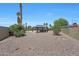 Desert landscaping, a gazebo with a hot tub, and privacy walls add to the outdoor appeal at 26649 S Howard Dr, Sun Lakes, AZ 85248
