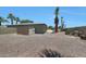 Desert landscaped backyard featuring a pool, shed, and lush greenery at 26649 S Howard Dr, Sun Lakes, AZ 85248