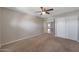Comfortable carpeted bedroom featuring a ceiling fan and closet for ample storage space at 26649 S Howard Dr, Sun Lakes, AZ 85248