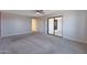 Large carpeted bedroom with lots of space and sliding glass door to outdoor space at 26649 S Howard Dr, Sun Lakes, AZ 85248
