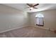 Neutral bedroom with a ceiling fan and a sunny window, offering a cozy retreat at 26649 S Howard Dr, Sun Lakes, AZ 85248