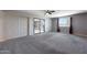 Bright bedroom featuring sliding glass doors, plush carpeting, and a sunny window at 26649 S Howard Dr, Sun Lakes, AZ 85248