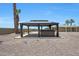 Gazebo with a hot tub surrounded by desert landscaping and palm trees at 26649 S Howard Dr, Sun Lakes, AZ 85248