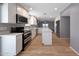 Bright kitchen features white cabinetry, stainless appliances, and a functional island, offering ample space at 26649 S Howard Dr, Sun Lakes, AZ 85248