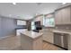 Updated kitchen with stainless appliances, white cabinets, quartz countertops, and a kitchen island at 26649 S Howard Dr, Sun Lakes, AZ 85248