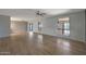 Bright living room featuring wood-look tile floors, neutral paint, and large windows for natural light at 26649 S Howard Dr, Sun Lakes, AZ 85248