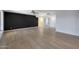 Spacious living room with black accent wall, tile floors, and multiple entryways at 26649 S Howard Dr, Sun Lakes, AZ 85248