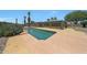 Backyard oasis offers a sparkling pool, desert landscaping, and a covered patio at 26649 S Howard Dr, Sun Lakes, AZ 85248