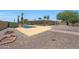 Backyard pool features a rock surround with desert landscaping and a covered patio at 26649 S Howard Dr, Sun Lakes, AZ 85248