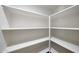 Spacious walk-in closet with built-in shelves, offering efficient storage and organization options at 26649 S Howard Dr, Sun Lakes, AZ 85248
