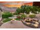 Relaxing backyard featuring a cozy fire pit, water feature, mature trees, and a hot tub, perfect for entertaining at 28878 N 127Th Ln, Peoria, AZ 85383