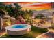 Inviting backyard with spa, fire pit, and seating area, perfect for outdoor entertaining and relaxation at 28878 N 127Th Ln, Peoria, AZ 85383