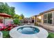 Inviting backyard with a spa, patio area, barbecue, and manicured landscaping at 28878 N 127Th Ln, Peoria, AZ 85383