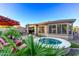 Beautifully landscaped backyard featuring a spa, patio area, and vibrant greenery at 28878 N 127Th Ln, Peoria, AZ 85383