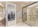 This bathroom has a glass shower and a walk-in closet with shelving for storage at 28878 N 127Th Ln, Peoria, AZ 85383