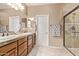 This bathroom features double sinks, a large mirror, and a glass shower at 28878 N 127Th Ln, Peoria, AZ 85383