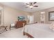 Spacious bedroom with a ceiling fan, TV, and doorway that provides access to an ensuite bathroom at 28878 N 127Th Ln, Peoria, AZ 85383