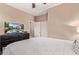 Bedroom with a bed, dresser with TV, and closet at 28878 N 127Th Ln, Peoria, AZ 85383