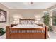 This bedroom features a wooden bedframe, bedside tables, and natural light from the windows at 28878 N 127Th Ln, Peoria, AZ 85383