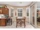 A bright breakfast nook features lots of windows and an adjacent wine storage unit at 28878 N 127Th Ln, Peoria, AZ 85383