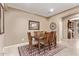This dining room has an elegant rug, a wooden table with chairs, and decorative wall art at 28878 N 127Th Ln, Peoria, AZ 85383