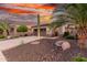 Attractive home with desert landscaping, including a mature palm and beautiful sky at sunset at 28878 N 127Th Ln, Peoria, AZ 85383
