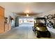 The garage contains a golf cart and storage and has an open view of the house across the street at 28878 N 127Th Ln, Peoria, AZ 85383
