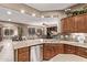 Kitchen features stainless steel appliances, granite counters, and a view into the Gathering room at 28878 N 127Th Ln, Peoria, AZ 85383