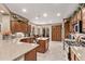 Spacious kitchen features wood cabinetry, granite counters, stainless steel appliances, and a breakfast bar at 28878 N 127Th Ln, Peoria, AZ 85383