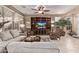 Spacious living room features neutral colors, a ceiling fan, and built-in entertainment center at 28878 N 127Th Ln, Peoria, AZ 85383