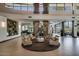 Grand lobby featuring a stone fireplace, comfortable seating, and views of the pool table and outdoor amenities at 28878 N 127Th Ln, Peoria, AZ 85383