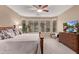 Bright primary bedroom features bay windows, neutral walls, ceiling fan and a large dresser at 28878 N 127Th Ln, Peoria, AZ 85383
