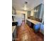 A view of the kitchen showcases a double sink, tile backsplash, and warm tile floors at 3211 W Campbell Ave, Phoenix, AZ 85017