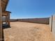 Expansive backyard featuring fresh landscaping and privacy wall at 37131 W Parador Ln, Maricopa, AZ 85138