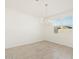 Bright dining room with tile flooring, modern chandelier, and large window at 37131 W Parador Ln, Maricopa, AZ 85138