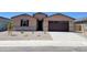 Charming single-story home with a well-maintained gravel front yard and a two-car garage at 37131 W Parador Ln, Maricopa, AZ 85138