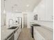 The kitchen features stainless appliances, granite countertops, and white cabinetry at 37131 W Parador Ln, Maricopa, AZ 85138